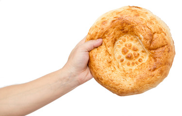 Fresh bread in his hand on a white background