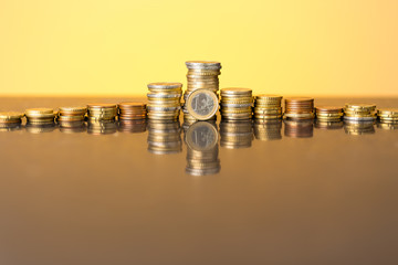 Stacks of coins with a golden glow