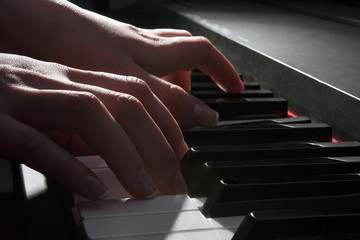 woman's hand playing the piano