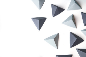 Creative abstract background with black and gray origami pyramids  with free copy space on the left side. Great for using in web.