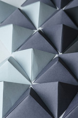 Obraz na płótnie Canvas Black and gray origami pyramids background. Futuristic polygonal composition is great for using in web.