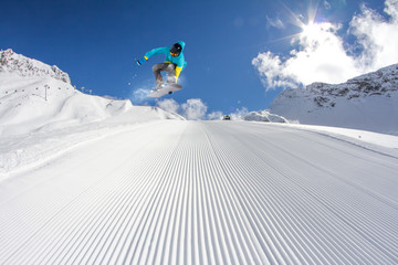 Flying snowboarder on mountains. Extreme sport.