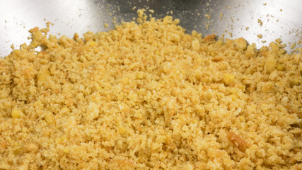 The close up of graham cracker crust mix with melted butter for pie or tart baking.