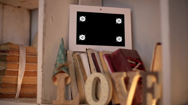 Mockup Video Displays Framework for Phototography are on the Shelf