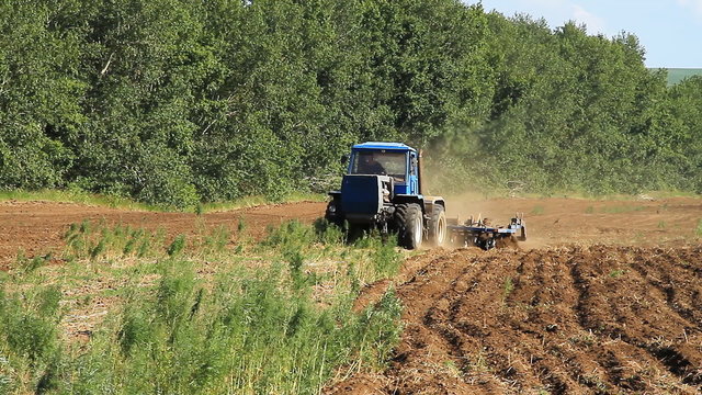 Farming. The Tractor Plows the Land.
