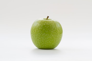 A fresh, green apple on an isolated white background.