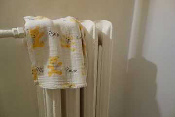 child towel on old radiator in bathroom