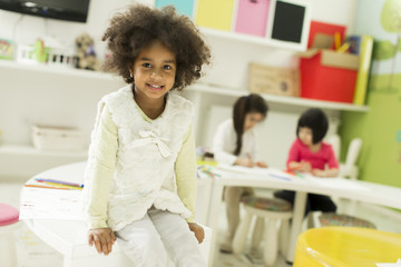 Multiracial children drawing in the playroom