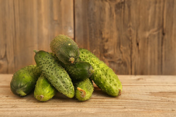 Harvest cucumbers on wooden background