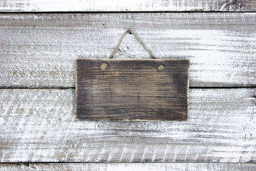 Blank wood sign hanging on rustic wooden background