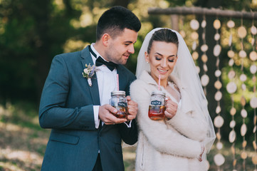 happy bride and groom walking in the autumn forest