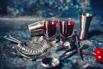 red cocktail shots of beverage. Strong, red vodka shots with cherry and delicios flavours.