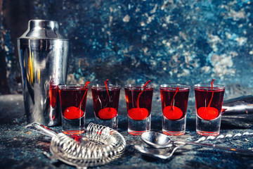 Red Alcoholic drink in shot glasses, aperitif and digestive drinks