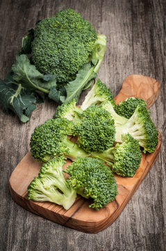Fresh raw organic broccoli wooden cutting board 