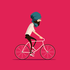 Fototapeta premium Hipster bearded man in a hat riding vintage bicycle. Guy cycling and listening music with modern green headphones wearing light shirt and tight brown jeans and trendy glasses.