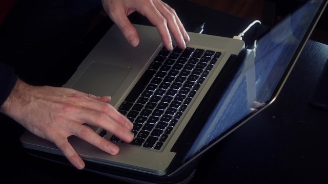 Hands typing on laptop in the dark. Male hands typing on computer in the dark - 1080p