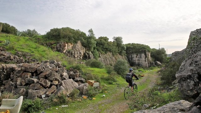 mountain bicycle riding through a rocky gorge 