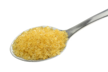 Brown sugar in a silver spoon on white