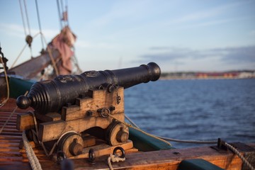 Old wooden war ship with a cannon
