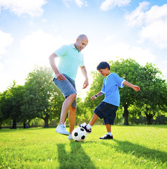 Little Boy Playing Soccer With His Father Concept