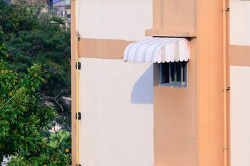 Rainproof awning of slide window on sunny day. © Eakkaluk