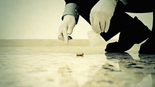 Crime scene CSI collecting bullet MS
