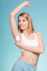 Fototapeta premium Girl applying stick deodorant in armpit.