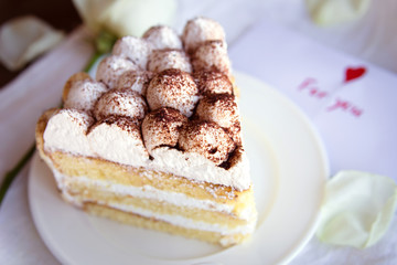 Tiramisu with a card and rose on the tray