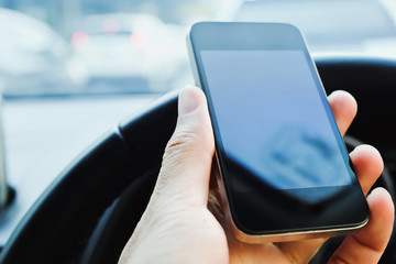 The use of mobile phones in the car and the traffic jam on the outside. urban lifestyle and communication technology concept.