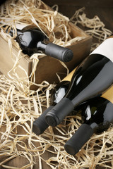 Wine bottles in wooden box and straw