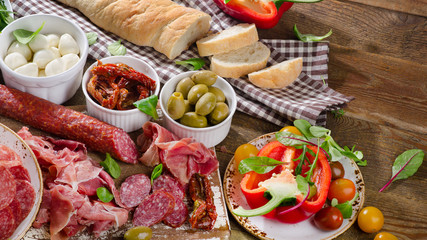 Italian antipasto on wooden table.
