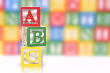 ABC blocks on a colorful blurred background