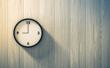 Fototapeta na wymiar Black clock hanging on the wood wall