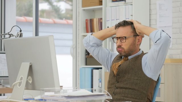 Middle-aged businessman trying to solve problem