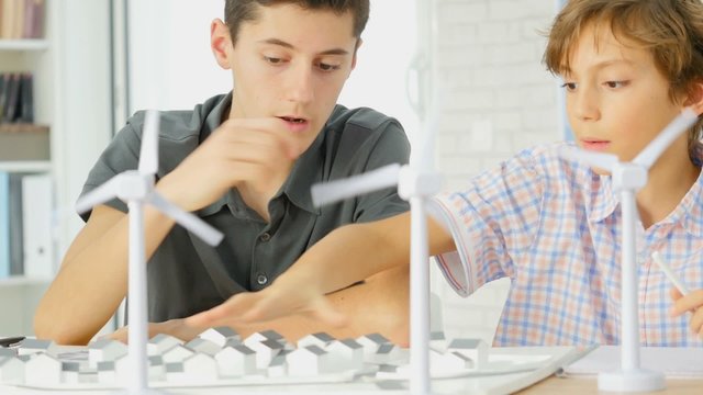 Closeup of teens at school learning about wind power