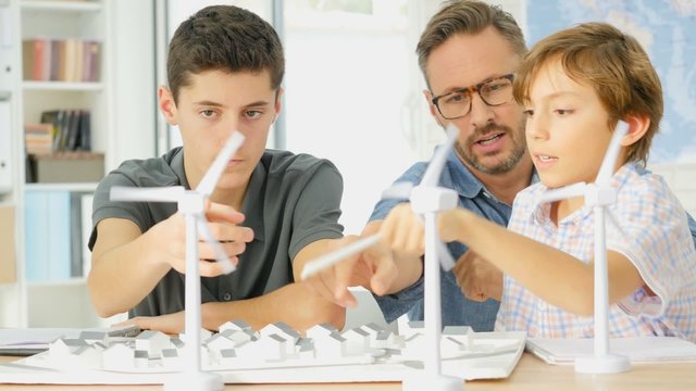 Teacher with teens at school learning about wind power