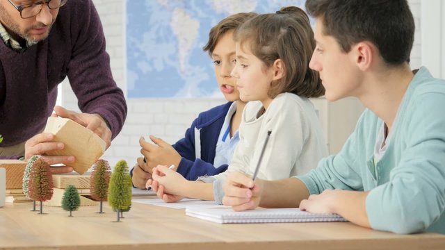 School teacher in science class with pupils