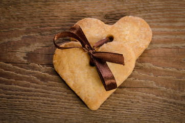  cookies-hearts related together on  wooden table