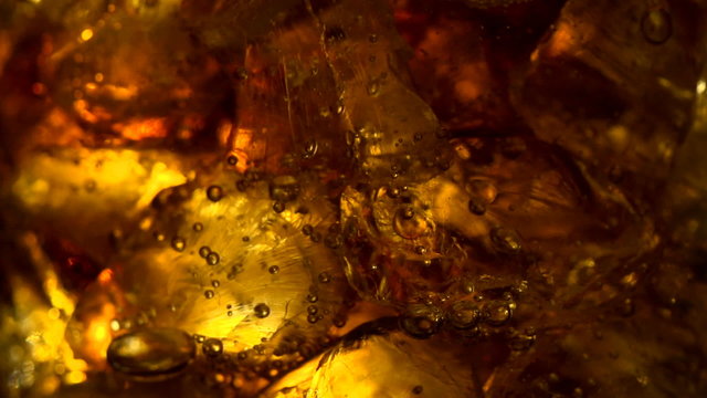 Close up view of the ice cubes in cola background