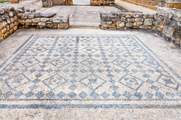 Room decorated with monochrome Roman mosaic pavement made with tesseras, in the House of the Swastika. Conimbriga in Portugal, is one of the best preserved Roman cities on the west of the empire.