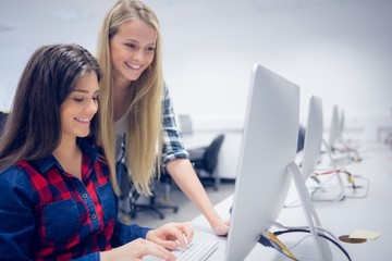 Smiling students using computer 