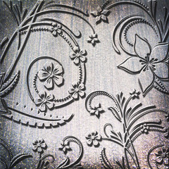 silver metal plate background with floral pattern