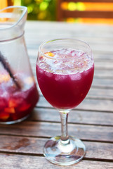 Glass filled with ice and sangria.