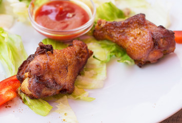 Grilled chicken wings with spicy ketchup.