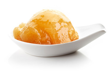 Honey in a white spoon