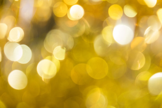 Gold glitter sparkle defocused rays lights bokeh abstract chistmas background.
