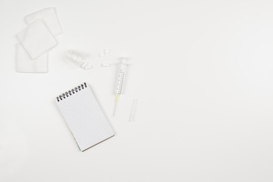 Top view of modern, sterile doctors office desk. Medical accessories on a white background with copy space around products. Photo taken from above.