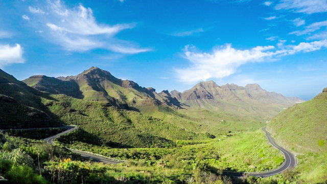 Beautiful landscape view with mountains, road serpantine and  clouds in Aldea region near San Nicolas city on the western part of Gran Canaria island. Time lapse video with zooming in