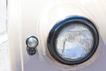Old car headlight. Retro style. Beige. Classic.