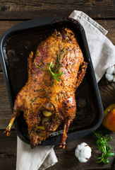 Roasted goose with apples in a rustic style